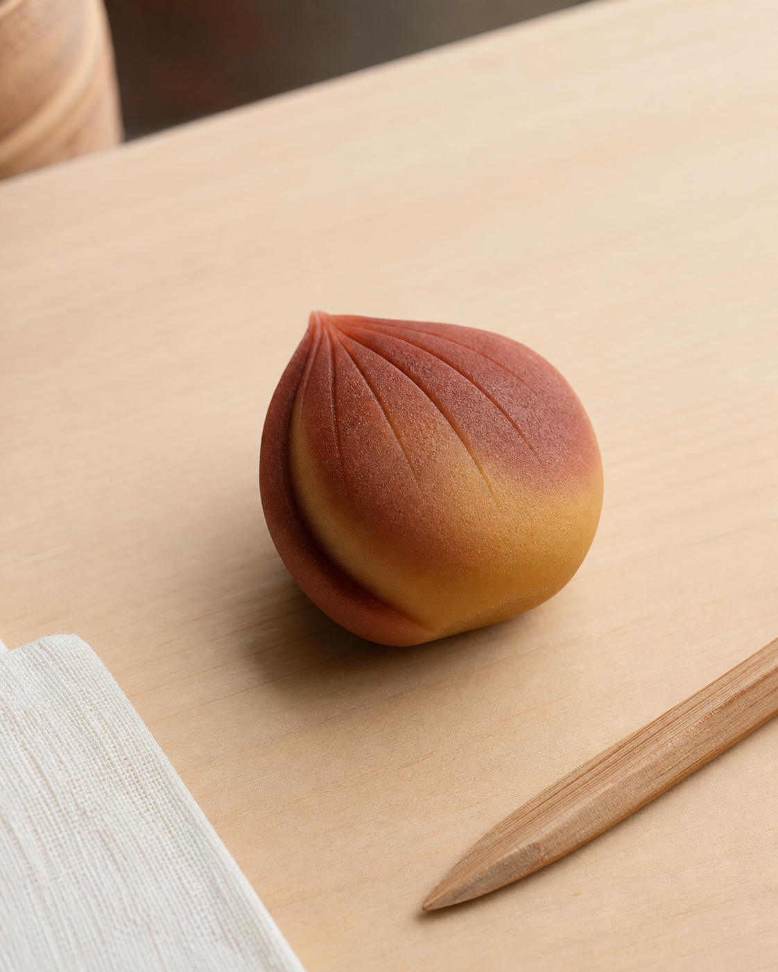 Close-up of nerikiri wagashi being shaped by hand using a traditional cloth tool