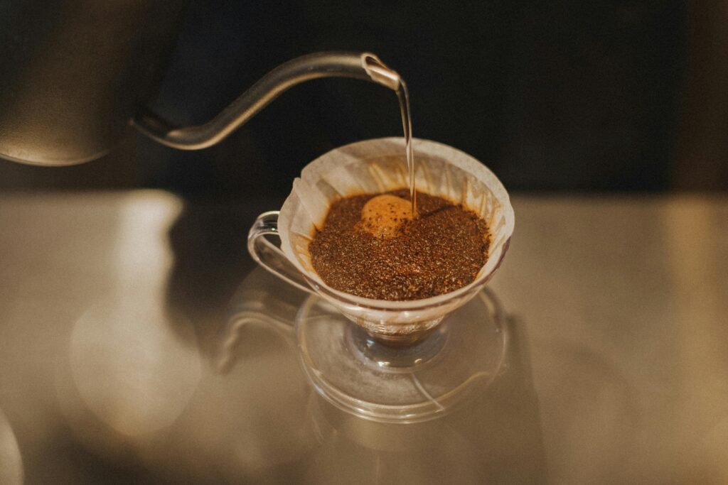 Close-up of pour-over coffee preparation in a Tokyo coffee shop. Warm and inviting atmosphere.